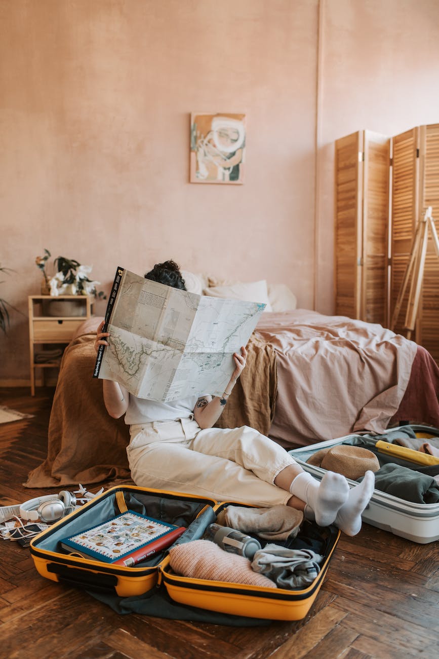 person in white pants lying on bed